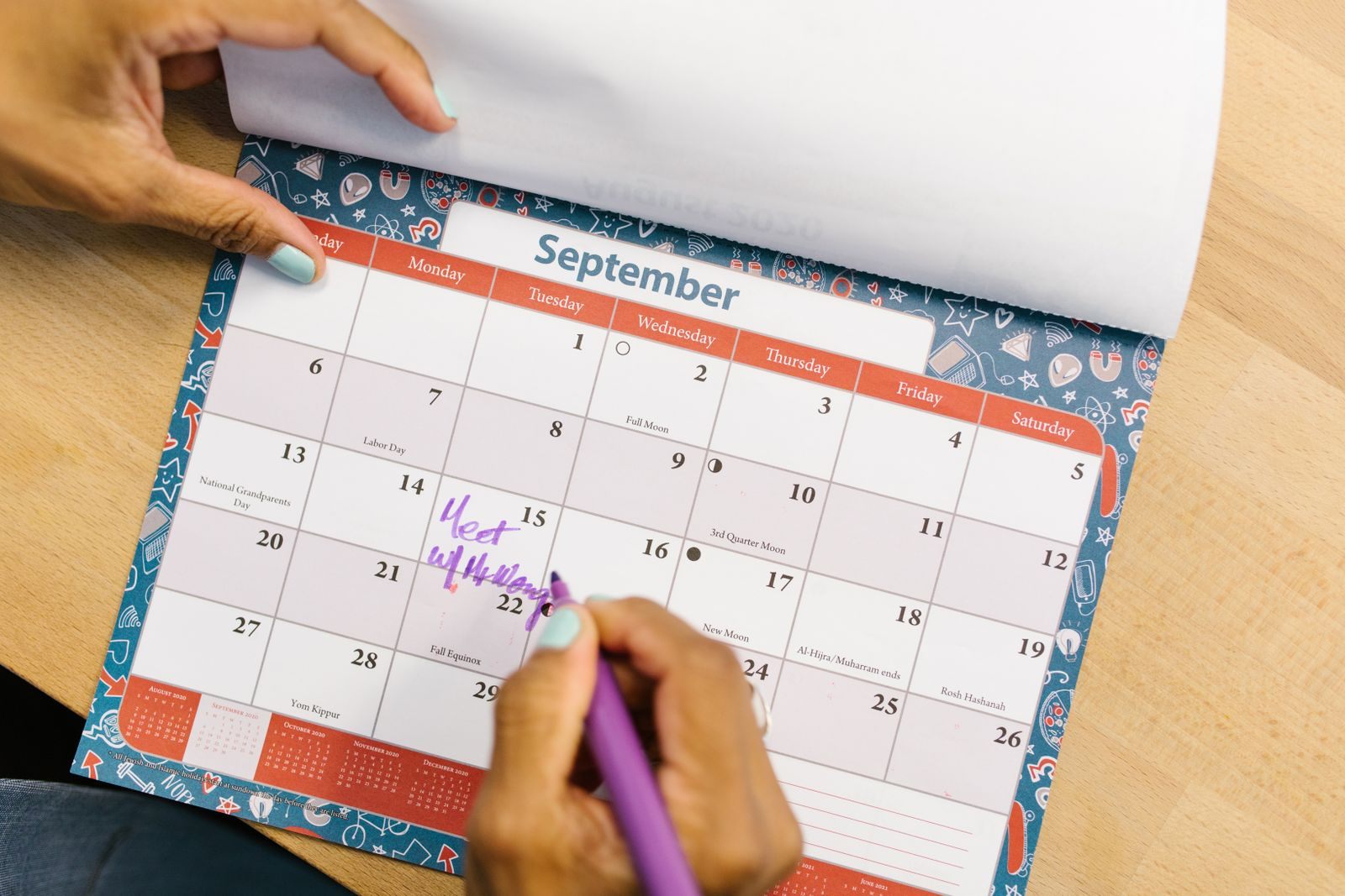 Hand marking a date on a wall calendar to check for a cruise price drop