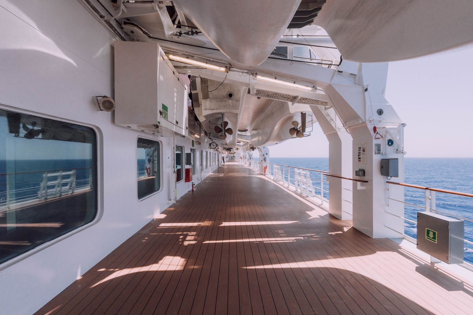 Long covered promenade deck along the side of a cruise ship