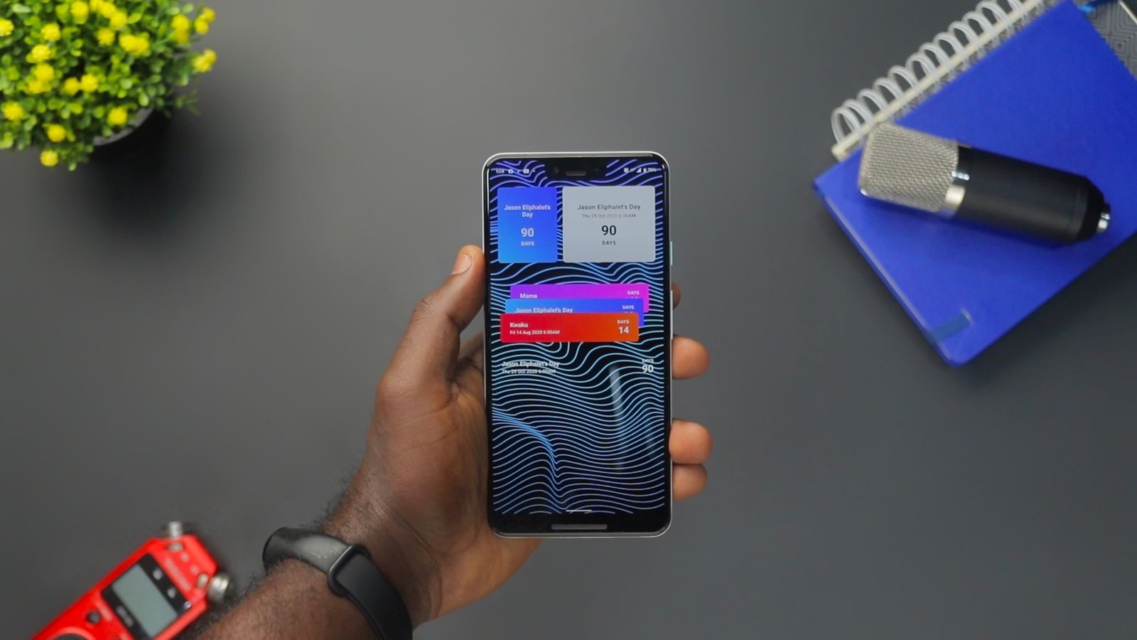 Hand holding a smartphone with reminder widgets, a simple cruise price drop tracker